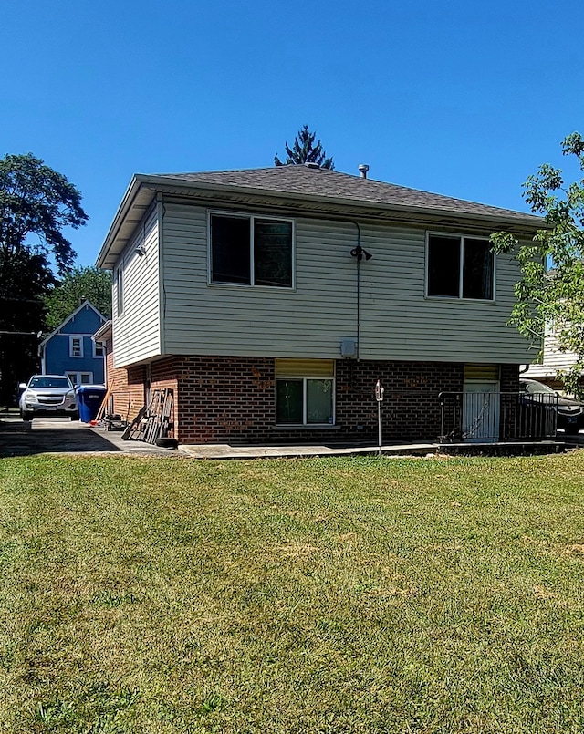 back of house with a lawn