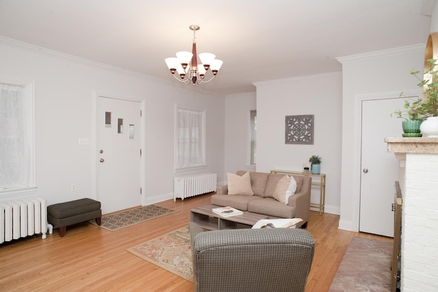 living room with radiator, hardwood / wood-style flooring, and a notable chandelier