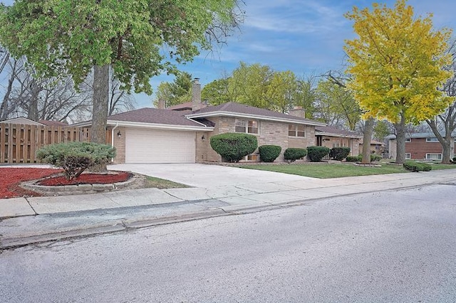 ranch-style house with an attached garage, fence, a chimney, and driveway