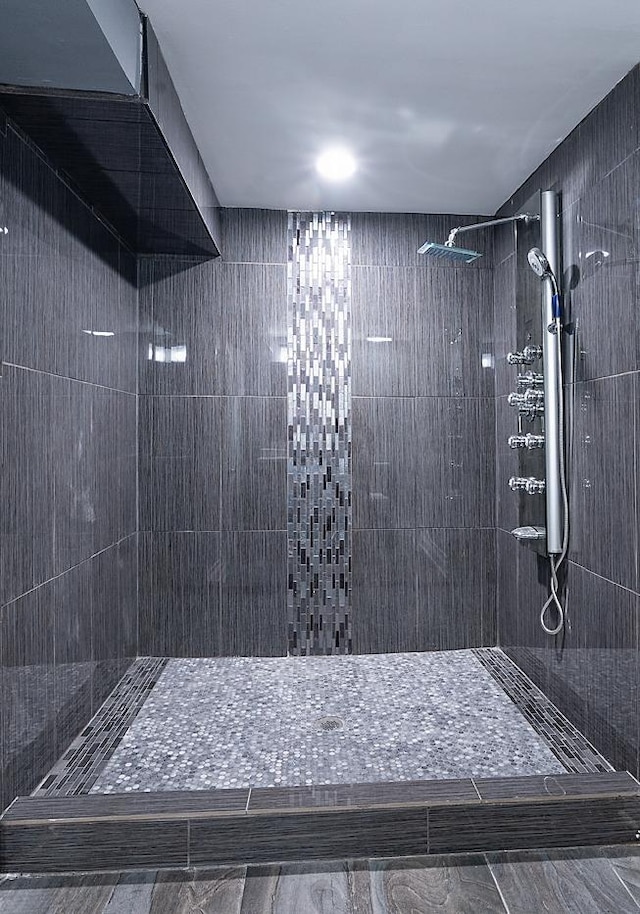 bathroom with tile walls and a tile shower