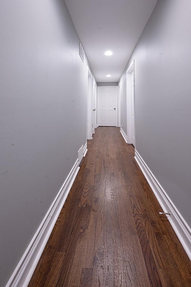 corridor with dark wood-type flooring