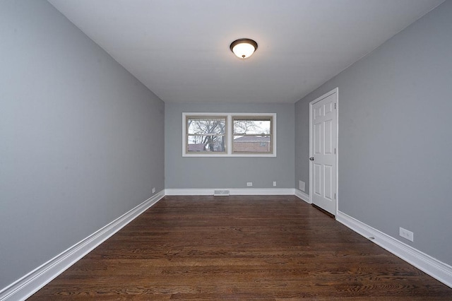 empty room featuring dark hardwood / wood-style floors