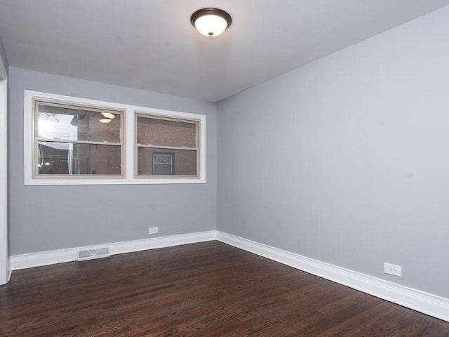 spare room with dark hardwood / wood-style flooring