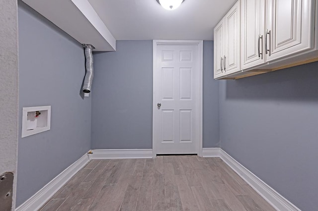 washroom featuring light hardwood / wood-style flooring, washer hookup, and cabinets