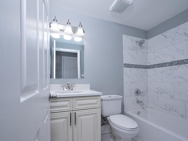 full bathroom featuring toilet, tiled shower / bath, and vanity