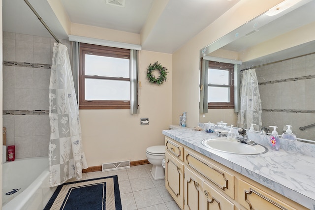 full bathroom with vanity, shower / tub combo, toilet, and a healthy amount of sunlight