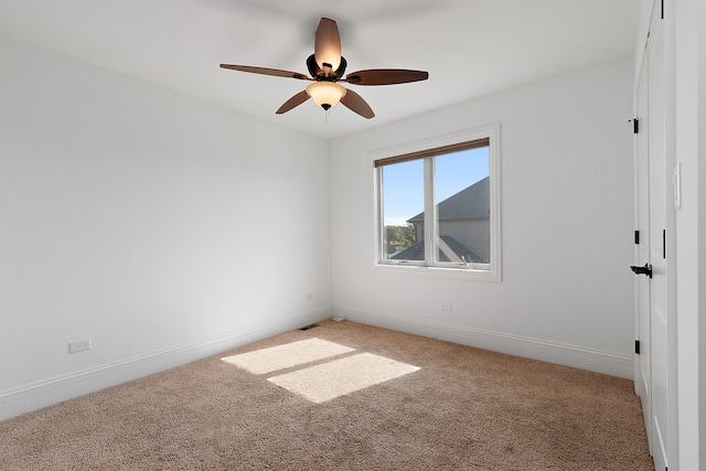 spare room featuring ceiling fan and carpet flooring