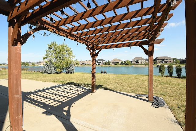 view of patio featuring a pergola and a water view