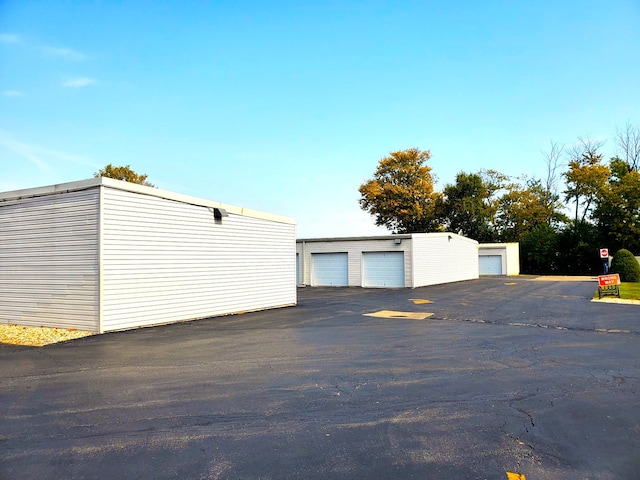 exterior space with an outbuilding and a garage