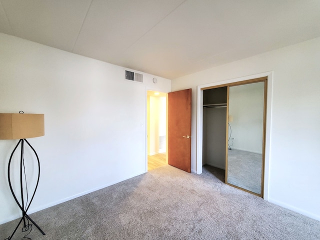 unfurnished bedroom with carpet flooring and a closet