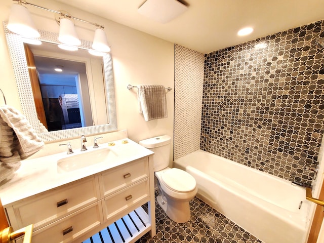 full bathroom with tiled shower / bath, tile patterned flooring, vanity, and toilet