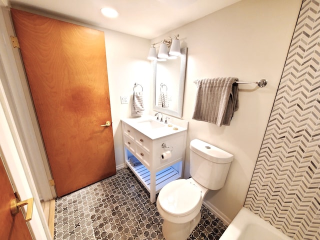 bathroom with vanity, toilet, and a bath