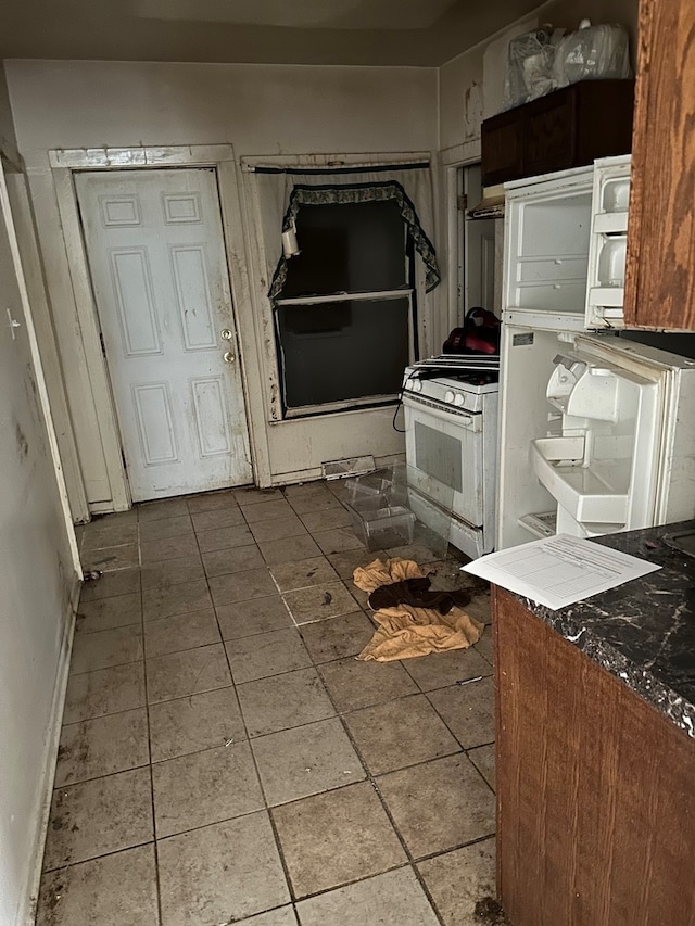 kitchen with gas range gas stove and tile patterned floors