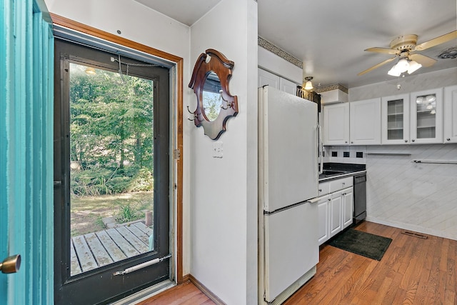 kitchen featuring light hardwood / wood-style floors, white cabinetry, and white refrigerator