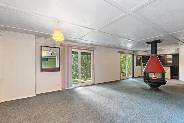 interior space featuring carpet flooring and a wood stove