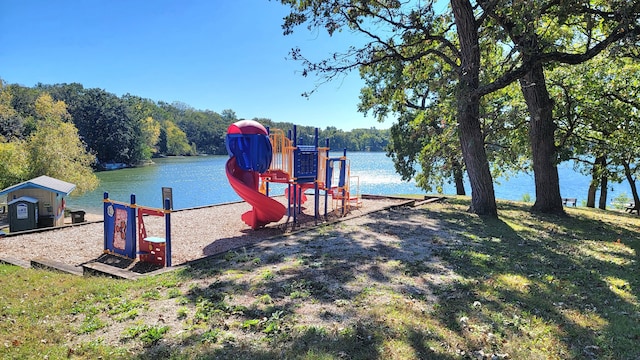 view of play area with a water view and a yard