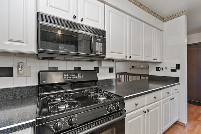 kitchen with white cabinets, light hardwood / wood-style flooring, decorative backsplash, and black appliances