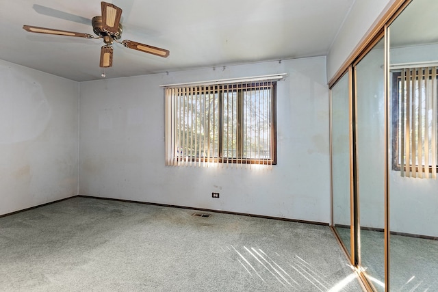 unfurnished room with carpet and ceiling fan