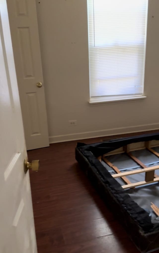 bedroom featuring dark hardwood / wood-style flooring