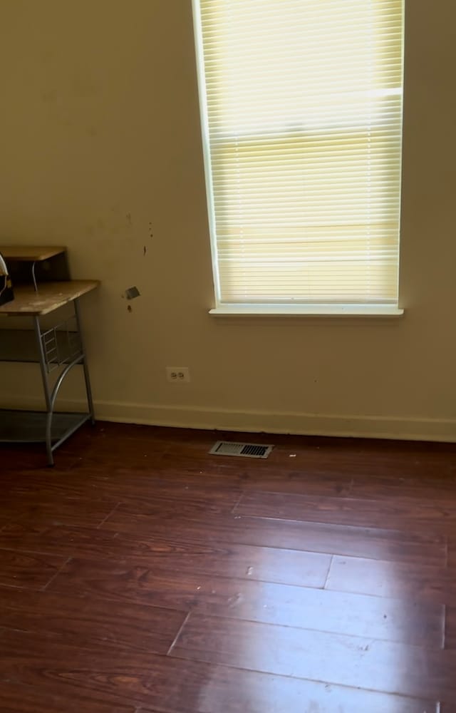 unfurnished room with hardwood / wood-style floors