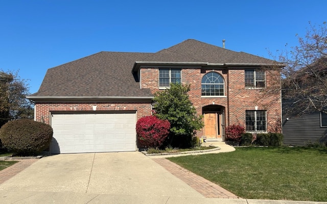 view of front facade with a garage and a front yard