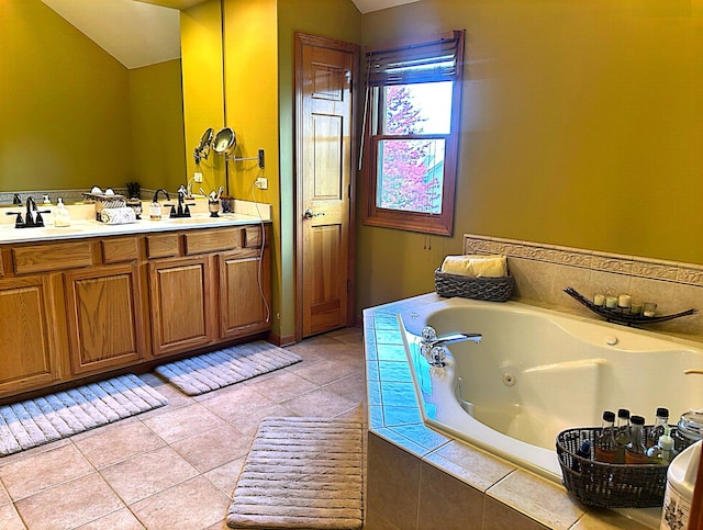 bathroom featuring vanity, tile patterned floors, and a relaxing tiled tub