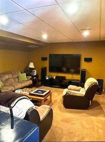 carpeted living room featuring a paneled ceiling