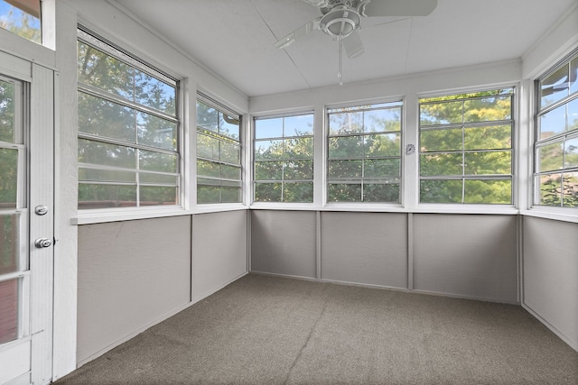 unfurnished sunroom featuring ceiling fan