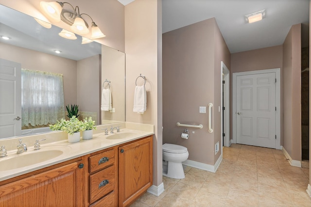 bathroom with vanity, toilet, and tile patterned floors