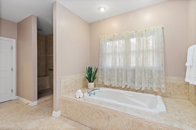 bathroom featuring plus walk in shower and tile patterned flooring