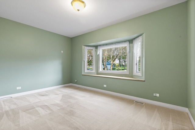 spare room with light carpet