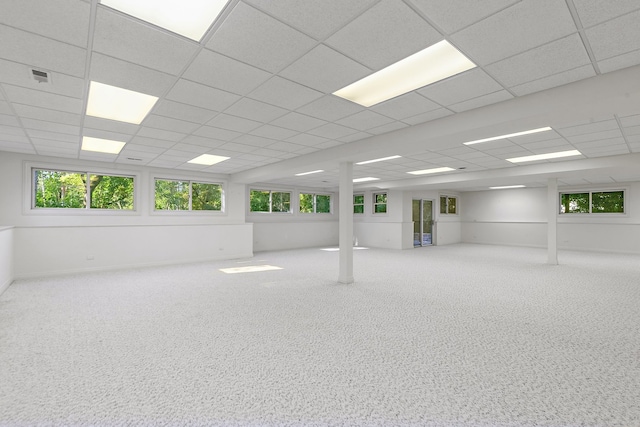 unfurnished room with a drop ceiling and carpet