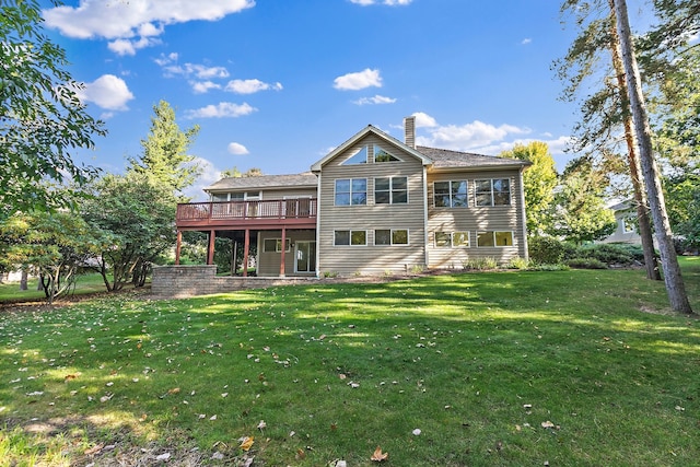 rear view of property featuring a wooden deck and a yard