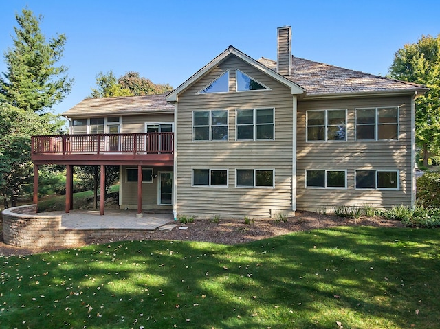 back of property with a patio, a deck, and a yard