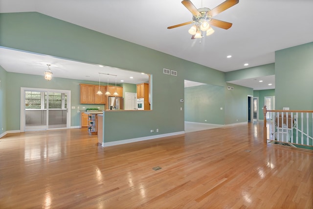 unfurnished living room with light hardwood / wood-style floors and ceiling fan