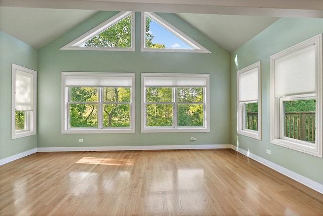 unfurnished sunroom featuring lofted ceiling and a wealth of natural light