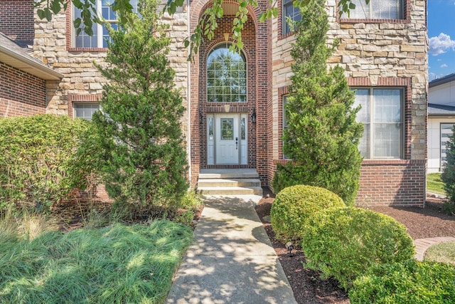 entrance to property with stone siding and brick siding