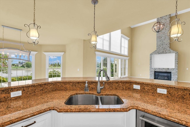 kitchen featuring a sink, decorative light fixtures, a healthy amount of sunlight, and beverage cooler