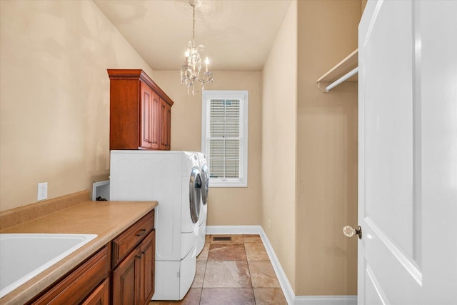 washroom with cabinet space, a sink, baseboards, visible vents, and a notable chandelier