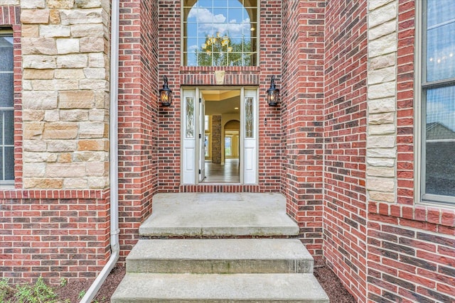 doorway to property with brick siding