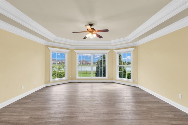 empty room featuring ornamental molding, wood-type flooring, and ceiling fan