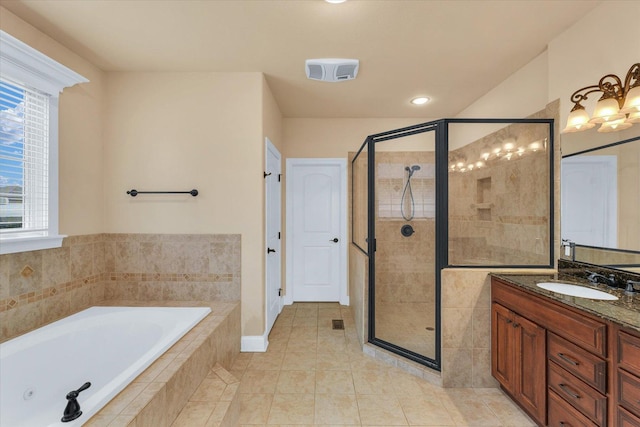 bathroom with a stall shower, a bath, tile patterned floors, and vanity