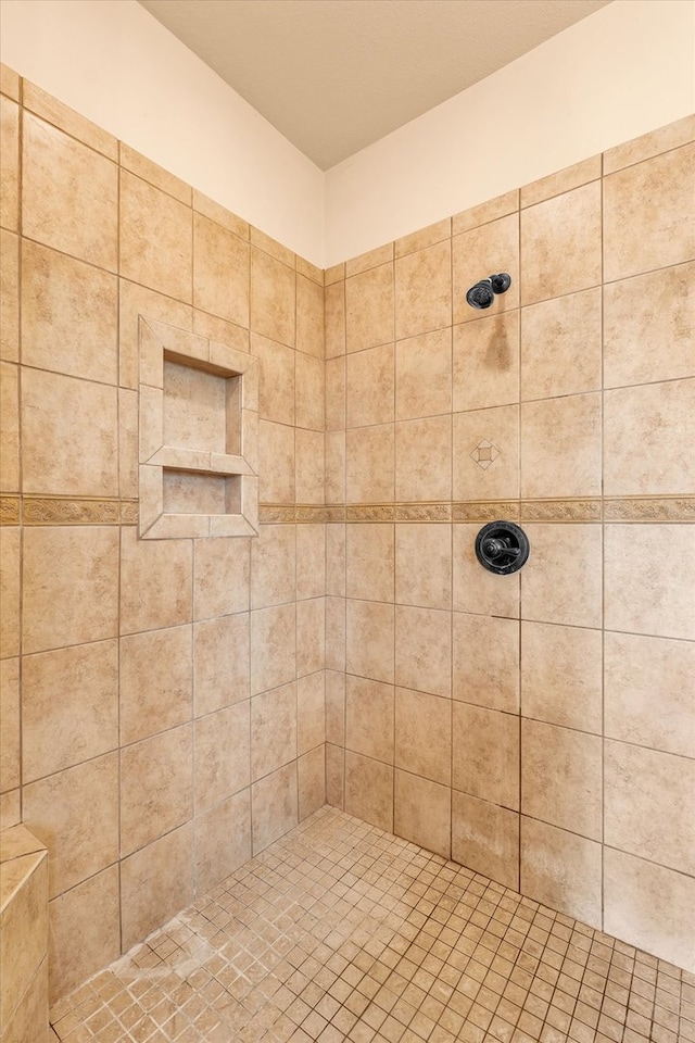 bathroom with a tile shower