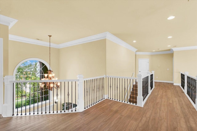 hall with recessed lighting, a chandelier, an upstairs landing, crown molding, and wood finished floors
