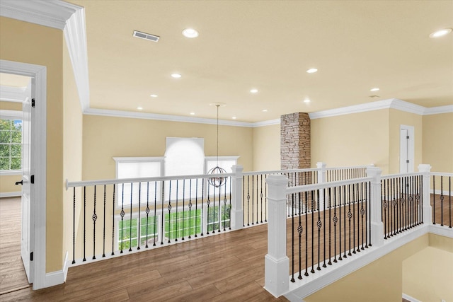 corridor featuring visible vents, baseboards, an inviting chandelier, recessed lighting, and wood finished floors