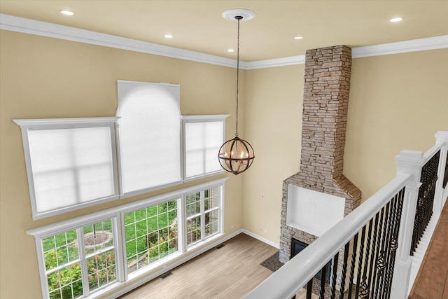 hall with wood finished floors, a chandelier, a healthy amount of sunlight, and recessed lighting