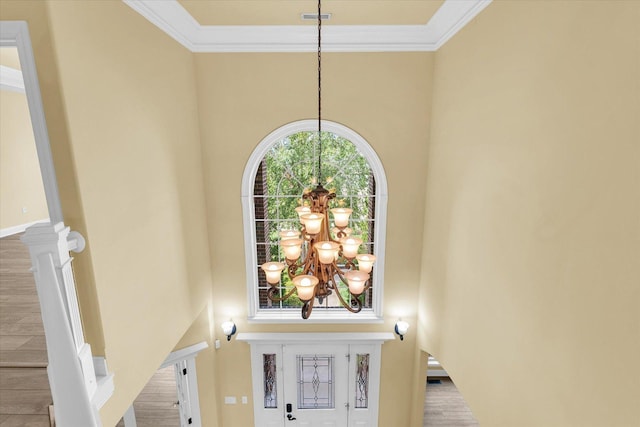 room details featuring visible vents, ornamental molding, and a notable chandelier