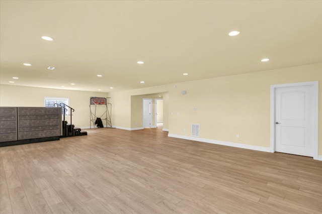 interior space with baseboards, light wood-type flooring, visible vents, and recessed lighting