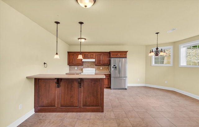 kitchen with decorative light fixtures, a notable chandelier, backsplash, stainless steel fridge with ice dispenser, and white electric stove