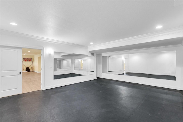 below grade area featuring crown molding, recessed lighting, and baseboards